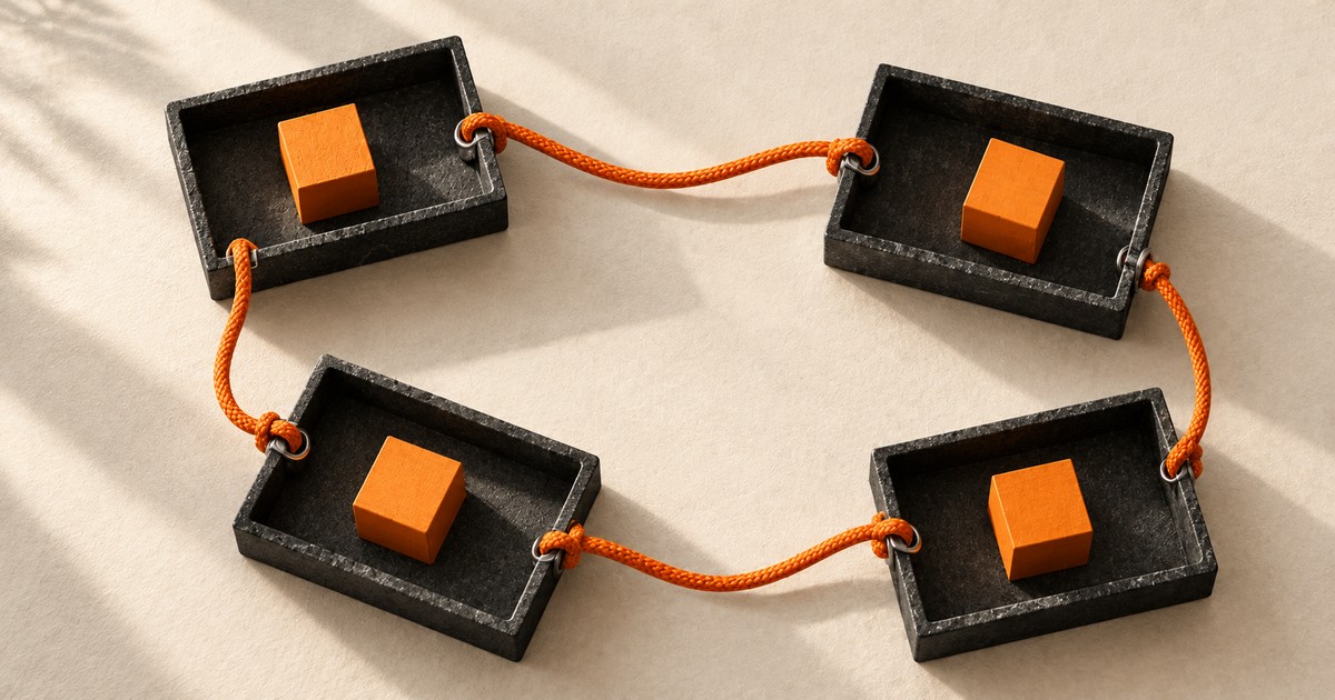 Four dark trays connected by an orange cord.