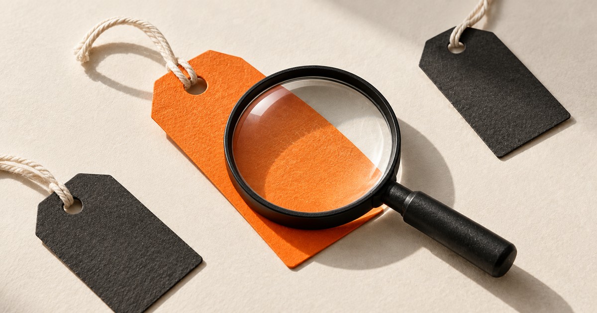 A magnifying glass over an orange product tag.